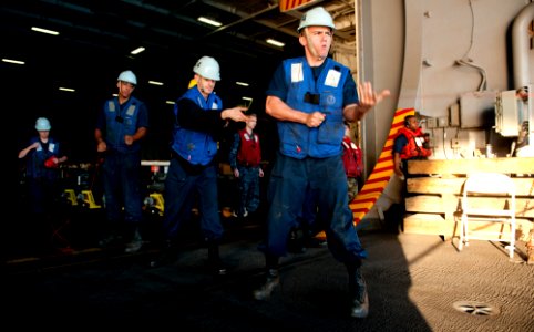 US Navy 111206-N-OY799-065 Sailors heave a messenger line during a replenishment at sea