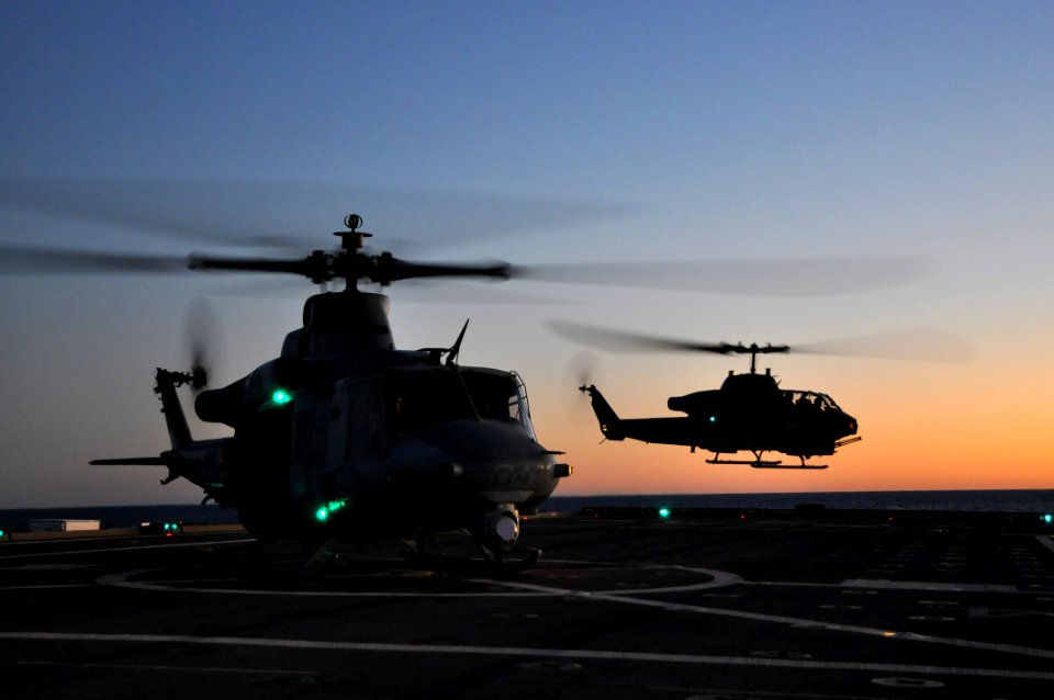 US Navy 111201-N-YX169-277 A UH-1Y Venom helicopter assigned to Marine Light Attack Helicopter Squadron (HMLA) 167 waits to take off as an AH-1W Su