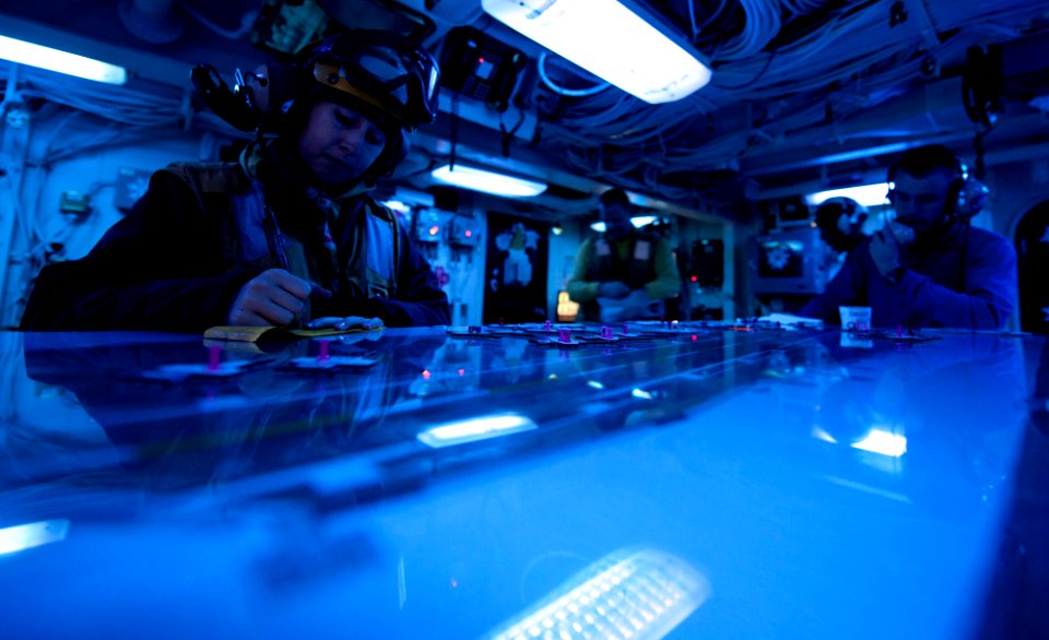 US Navy 111203-N-OY799-272 Aviation Boatswain's Mate (Handling) 3rd Class Taylor Maxwell takes notes before flight operations in flight deck contro