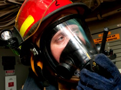 US Navy 111201-N-PB383-835 Damage Controlman 2nd Class Joshua Nightengale communicates over the radio during a damage control exercise aboard the a