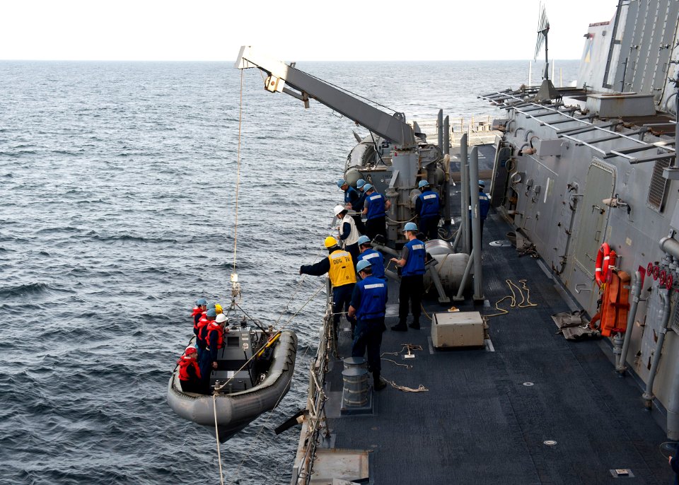 US Navy 111206-N-FI736-019 Sailors aboard the Arleigh Burke-class guided-missile destroyer USS Porter (DDG 78) lower a rigid-hull inflatable boat i