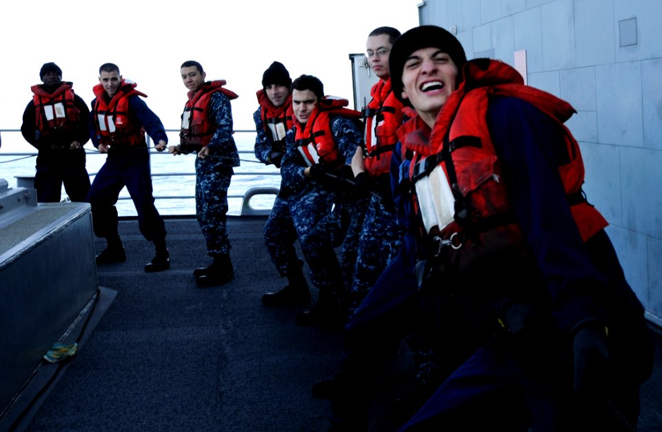 US Navy 111202-N-BC134-209 Sailors aboard the guided-missile cruiser USS Bunker Hill (CG 52) pull a communication line from the Military Sealift Co