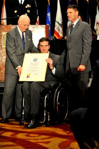 US Navy 111206-N-IL267-002 John Campbell, Deputy Assistant Secretary of Defense for Wounded Warrior Care and Transition Policy, presents Dr. Willia