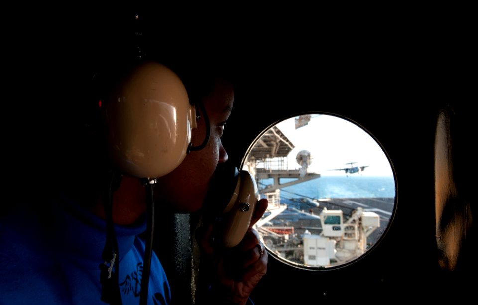 US Navy 111205-N-OY799-195 Aviation Boatswain's Mate (Handling) Airman Erin Johnson, from Philadelphia, observes flight operations in the integrate