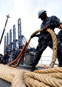US Navy 111203-N-WJ771-049 A Sailor heaves around on a mooring line