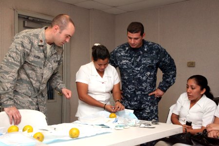 US Navy 111206-A-IP644-114 Maj. Brant Lutsi, left, a doctor assigned to High Speed Vessel (HSV) 2 Swift, and Petty Officer 2nd Class Miguel Rivera photo