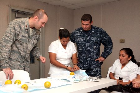 US Navy 111206-A-IP644-114 Maj. Brant Lutsi, left, a doctor assigned to High Speed Vessel (HSV) 2 Swift, and Petty Officer 2nd Class Miguel Rivera