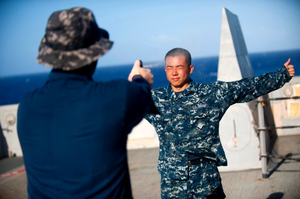 US Navy 111203-N-PB383-623 Logistics Specialist Seaman Guanglei Liu gets sprayed with Oleoresin Capsicum (OC) by Aviation Ordnanceman 1st Class All