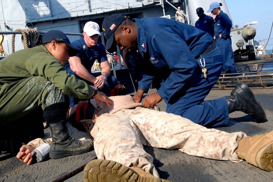 US Navy 111207-N-GH121-189 Sailors demonstrate administering proper first aid during a fire and mass casualty drill on the flight deck of the amphi