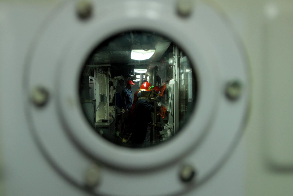 US Navy 111203-N-DU438-190 Sailors brace for shock during a total ship survivability exercise aboard the guided-missile cruiser USS Gettysburg (CG