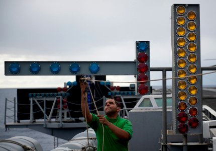 US Navy 111206-N-DR144-779 Interior Communications Electrician 3rd Class Emmanuel Camilo practices rigging the manually operated visual landing aid