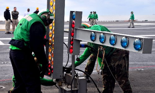 US Navy 111205-N-OP638-001 Sailors assigned to the aircraft carrier USS Enterprise (CVN 65) assemble the emergency signal lights during a flight de