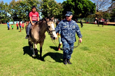 US Navy 111207-A-TF780-362 Lt. Cmdr. Ken Creameans, officer in charge of Military Detachment aboard High Speed Vessel (HSV 2), assists with El Salv photo