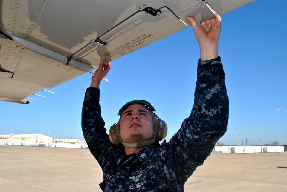 US Navy 111207-N-GO535-115 Aviation Machinist's Mate 2nd Class Ron Dischler, assigned to Fleet Logistics Support Squadron (VR) 59, inspects the ail