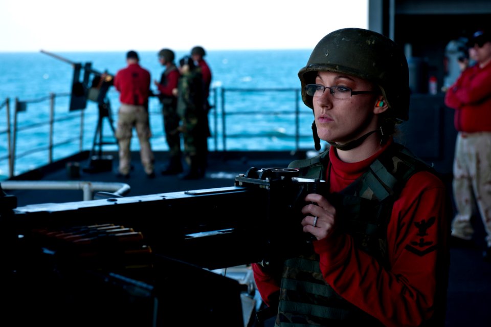 US Navy 111207-N-BT887-204 Aviation Ordnanceman 3rd Class Emily Walker, from Nashville, Ind., prepares to fire a .50-caliber machine gun during a l