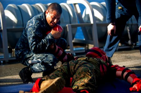 US Navy 111203-N-PB383-675 Aviation Support Equipment Technician 2nd Class Oscar Ochoa puts a simulated attacker in a physical restraint after bein