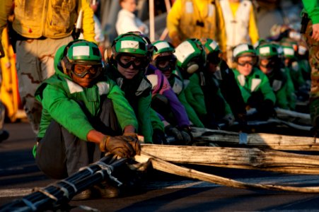 US Navy 111207-N-OY799-404 Air Department Sailors set up the barricade on the flight deck of the Nimitz-class aircraft carrier USS John C. Stennis