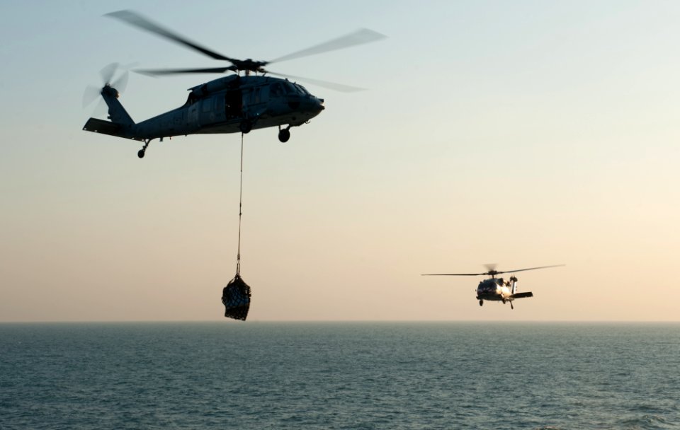 US Navy 111206-N-OY799-044 Helicopter delivers stores to ship
