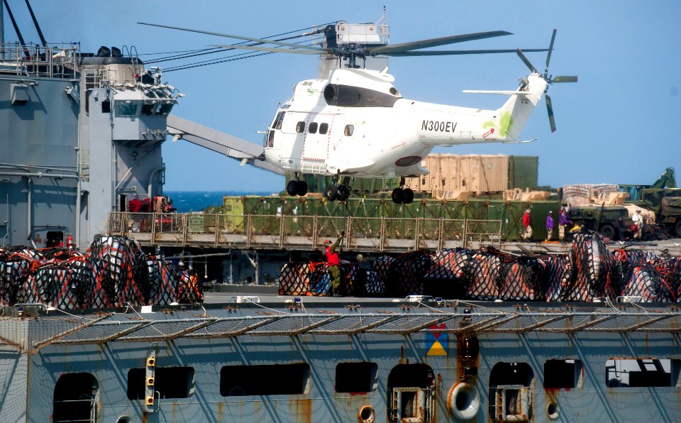 US Navy 111210-N-PB383-914 A helicopter from the Military Sealift Command dry cargo and ammunition ship USNS Alan Shepard (T-AKE 3) prepares to del