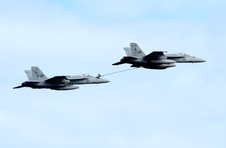 US Navy 111209-N-QL471-267 A jet performs an in-flight refueling during an air power demonstration