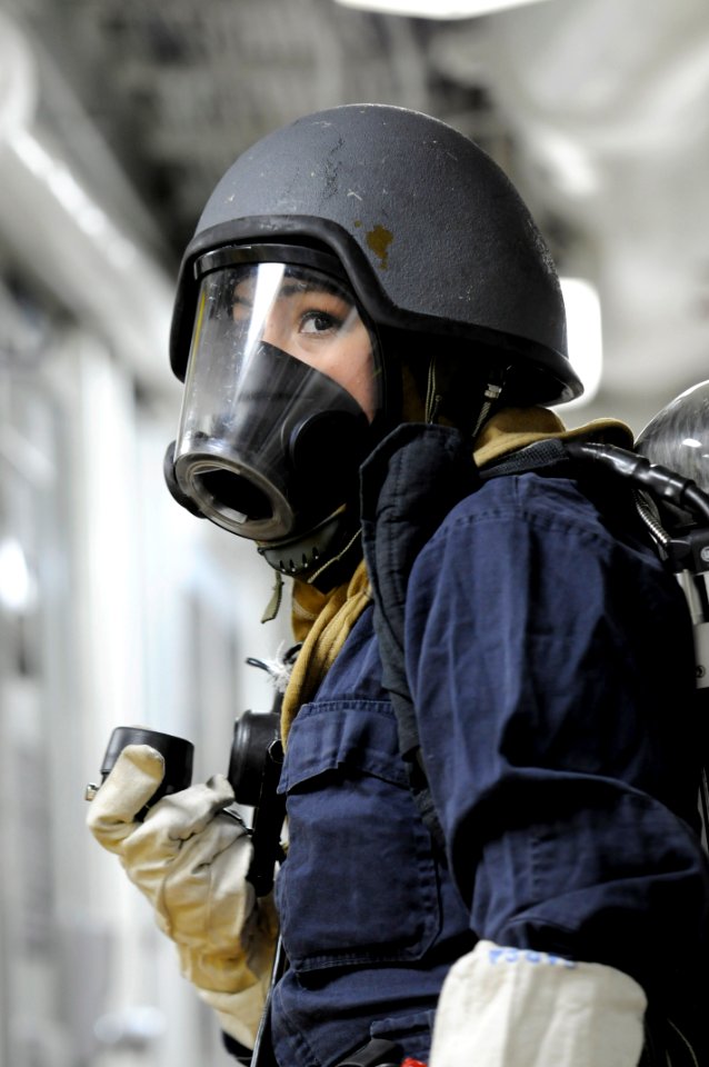 US Navy 111207-N-DB801-289 Damage Controlman Fireman Alina Barba awaits instructions during an integrated training team damage control drill aboard