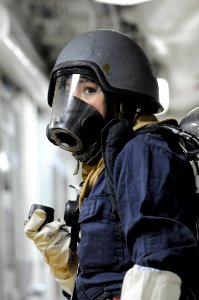 US Navy 111207-N-DB801-289 Damage Controlman Fireman Alina Barba awaits instructions during an integrated training team damage control drill aboard
