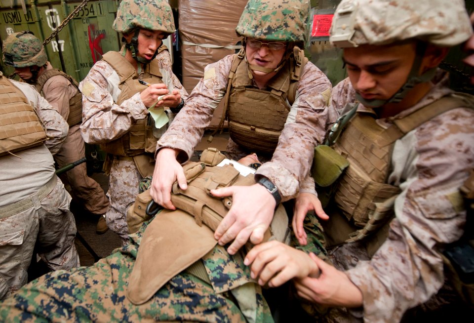 US Navy 111209-N-PB383-226 ospital corpsmen assigned to the 11th Marine Expeditionary Unit (11th MEU) assess a simulated casualty in the well deck