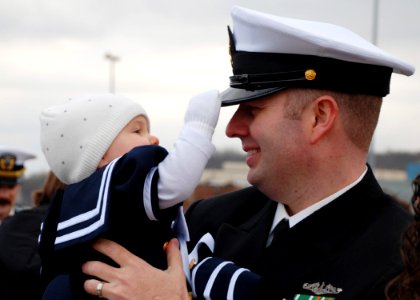 US Navy 111214-N-AW342-136 Chief Yeoman Matthew Gilliam is greeted by his daughter after returning from a scheduled 6-month deployment aboard the L