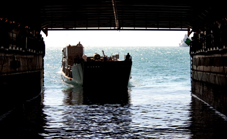 US Navy 111211-N-KS651-132 A landing craft utility approaches the well deck of the amphibious dock landing ship USS Pearl Harbor (LSD 52)