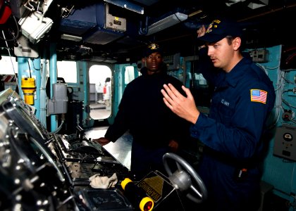 US Navy 111206-N-FI736-097 Boatswain's Mate Seaman Cameron Fitzgibbon, right, teaches Boatswain's Mate Seaman Brandon Williams how to stand watch a