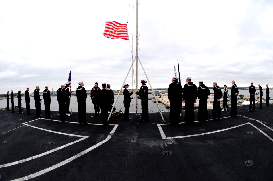 US Navy 111208-N-QL471-201 Sailors raise the Union Jack during morning colors aboard the aircraft carrier USS George H.W. Bush (CVN 77) as the ship