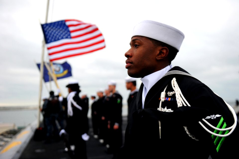 US Navy 111208-N-XE109-195 Aviation Boatswain's Mate (Handling) Airman Terence Thornton mans the rails as the aircraft carrier USS George H.W. Bush