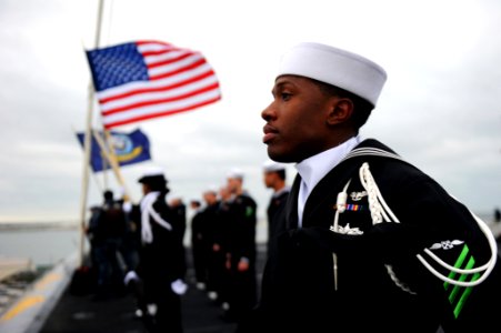 US Navy 111208-N-XE109-195 Aviation Boatswain's Mate (Handling) Airman Terence Thornton mans the rails as the aircraft carrier USS George H.W. Bush