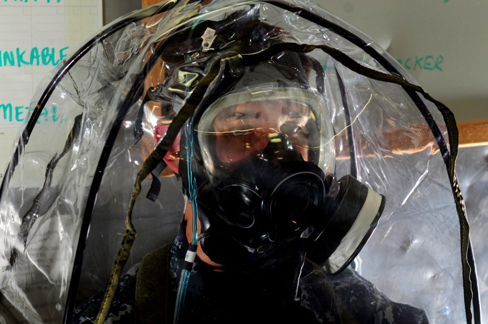 US Navy 111207-N-RG587-012 viation Support Equipment Technician Airman Apprentice Brian Teiken wears a joint service mask leakage detector canopy t