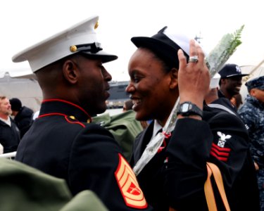 US Navy 111210-N-YF306-148 A Sailor is embraced by her husband