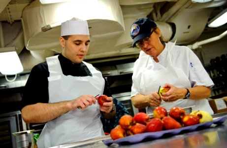 US Navy 111211-N-GC412-118 Culinary Specialist Seaman Matthew Ryback trains alongside Master Baker Chef Leslie Bilderback in the bakeshop aboard th photo