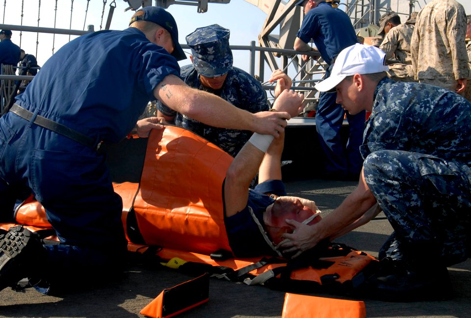 US Navy 111207-N-GH121-192 Sailors demonstrate administering proper first aid during a fire and mass casualty drill on the flight deck of the amphi