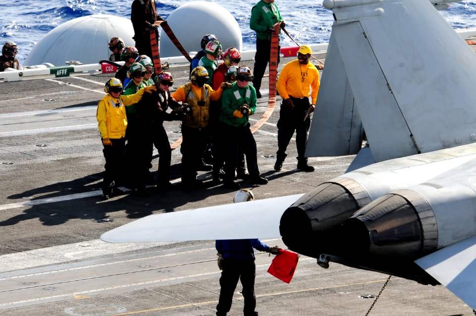 US Navy 111207-N-RG587-153 Sailors fight a simulated fire on an F-A-18C Hornet on the flight deck aboard the Nimitz-class aircraft carrier USS Carl