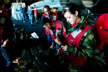 US Navy 111213-N-BT887-199 Aviation Ordnanceman 3rd Class Alexis Johnson, from Omaha, Neb., loads rounds into a magazine for small-arms qualificati