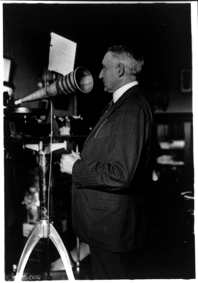 Warren Gamaliel Harding, 1865-1923, three-quarters length, speaking into funnel microphone, making voice recording LCCN2006689846