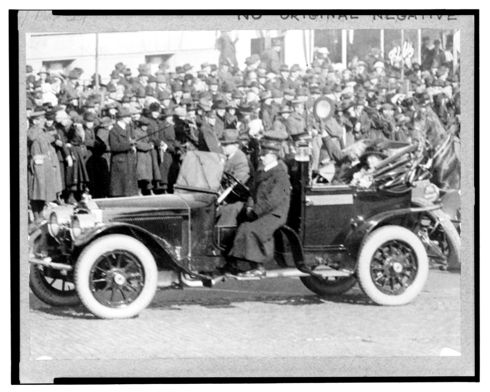Warren Harding and Mrs. Harding seated in the back of a convertible automobile enroute to or from the U.S. Capitol on the day of his inauguration LCCN2004673404