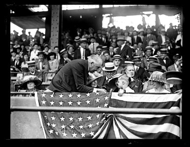 Warren Harding speaking to child in stands LCCN2016891430