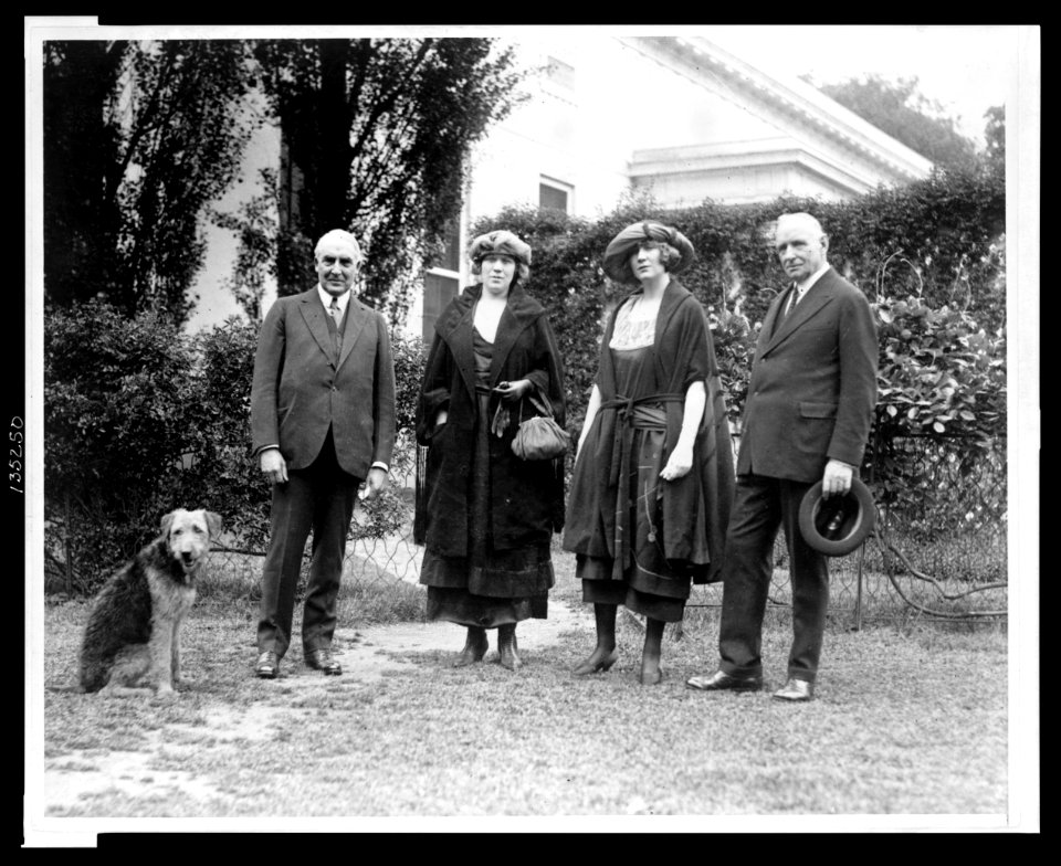 Warren Harding with pet dog Laddie Boy in the yard at the White House, with Pop Anson and his daughters LCCN2005677276
