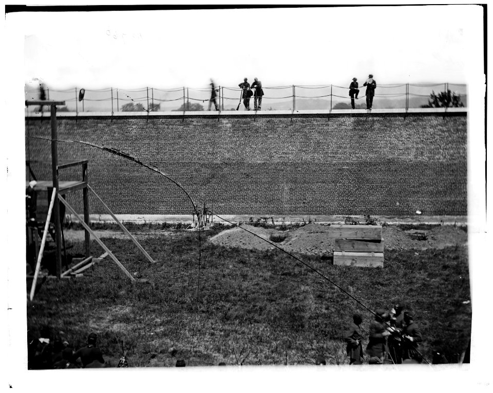 Washington, D.C. Coffins and open graves ready for the conspirators' bodies at right of scaffold LOC cwpb.04201