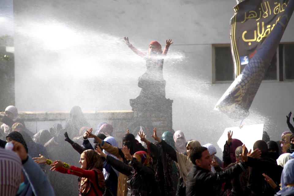 Water cannon fired on female Islamist students - protest at Al-Azhar University Cairo 11-Dec-2013