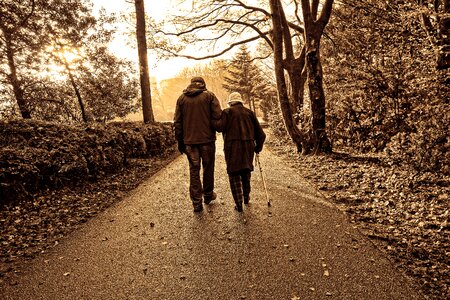 Walking white cane arm in arm
