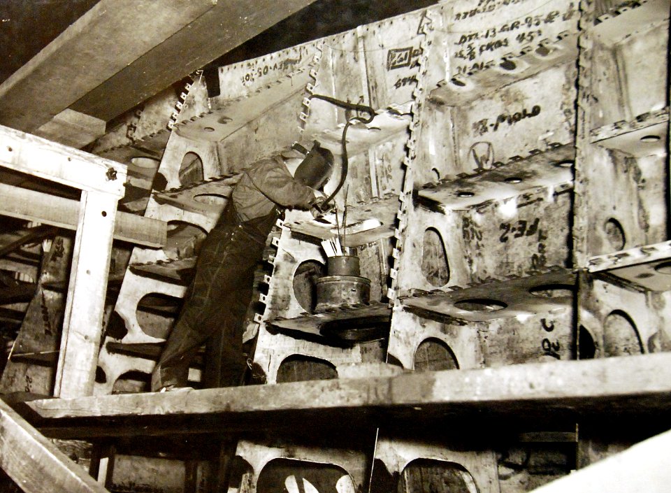 Welder working on nose section of new destroyer, Norfolk Naval Ship Yard, Virginia, 1941 (26156179190)