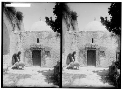 Weli of Budrieh at Sherafat and the preparing of a sacrifice. Ornamented entrance to the tomb. LOC matpc.01414