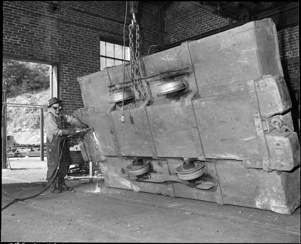 Welding a coal shuttle car in machine shop. The Pocahontas Corporation Mines 33-34, Bishop, Tazewell County, Virginia. - NARA - 541073
