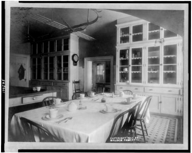 White House kitchen with set table and cupboards LCCN92507758